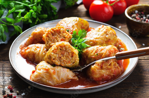 Cabbage Rolls with Ground Meat, Rice and Vegetables also known as Sarma, Golubtsy, Dolma on Rustic Wooden Background photo