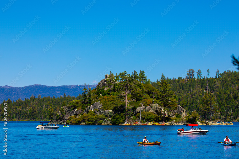 View of Fannette Island, boaters and kayakers in Emerald Bay, Lake Tahoe California from the shore