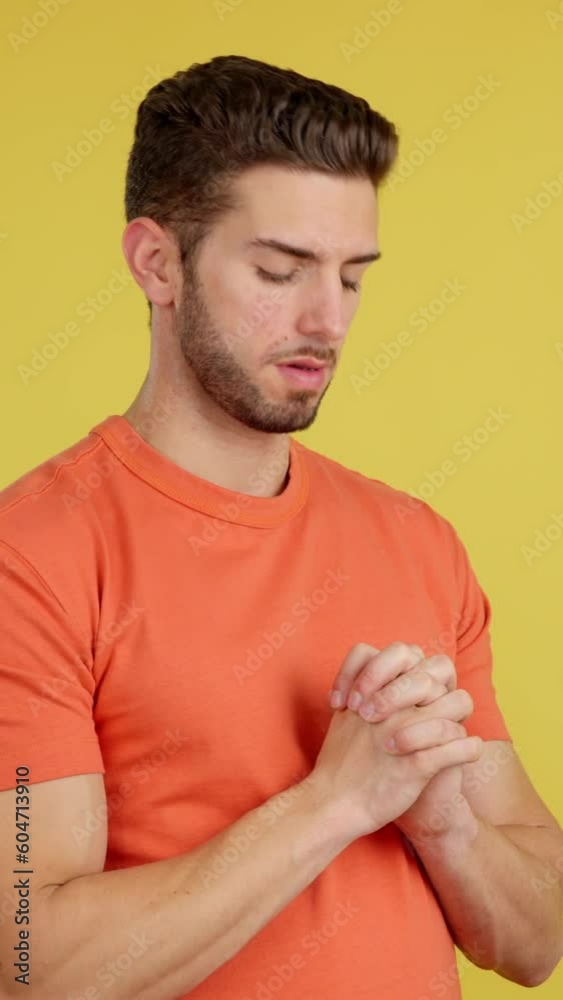 Caucasian man looking up while praying with folded hands