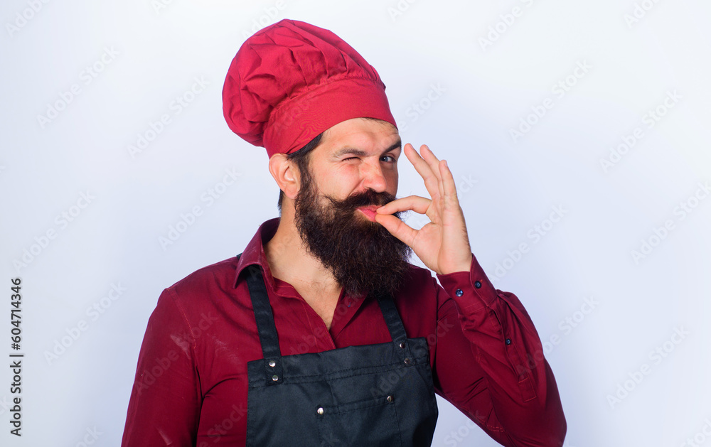 Professional chef in uniform shows sign ok. Winking bearded chef, baker gesturing excellent. Male cook in chef hat with perfect sign. Chef with taste approval gesture, sign for delicious. Restaurant. Professional chef in uniform shows sign ok. Winking bearded chef, baker gesturing excellent. Male cook in chef hat with perfect sign. Chef with taste approval gesture, sign for delicious. Restaurant.