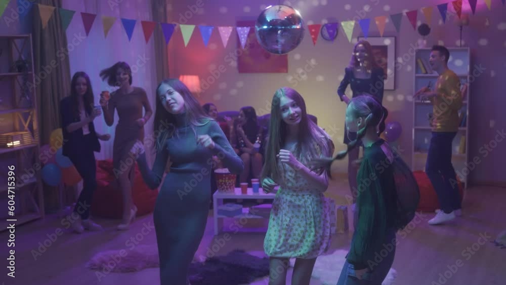 At the party, teenagers dance in separate groups. A group of three girls dance separately, hold hands and bounce together. Dance of three girlfriends close up. HDR BT2020 HLG Material.