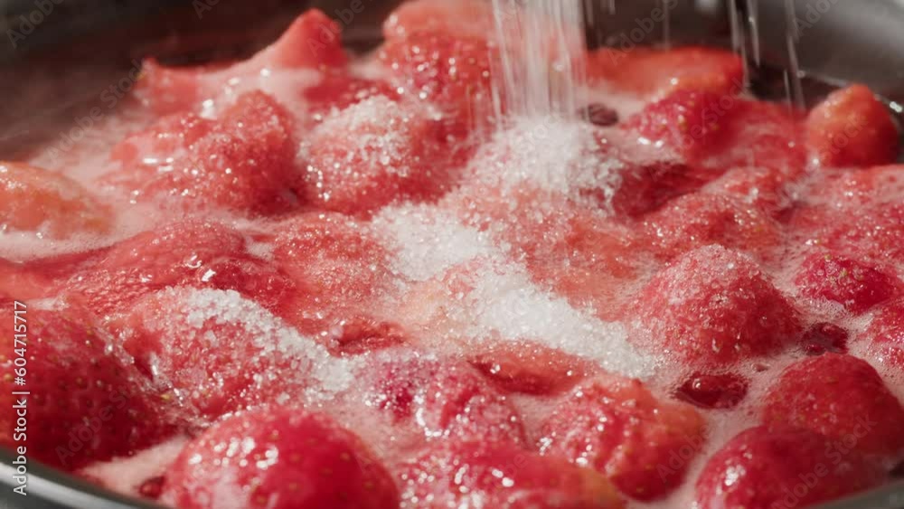 Cooking fruits Jam, Process of making homemade strawberry jam. Red sweet syrup boiling on the stove closeup. Boiling Homemade Strawberry dessert jam macro. 