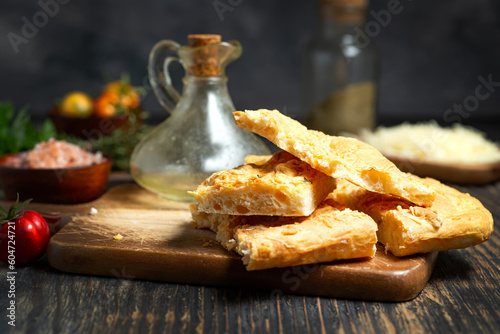Fresh Italian focaccia bread close up on Durk table. photo