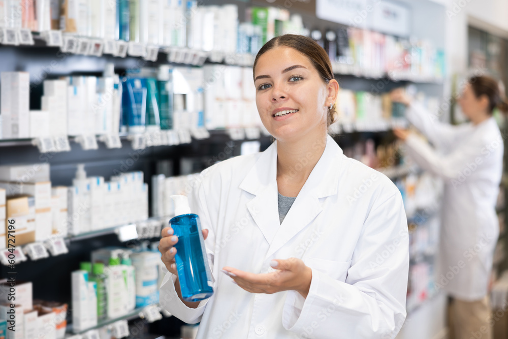 Female pharmacist offers cosmetics products while standing in the trading floor of a pharmacy