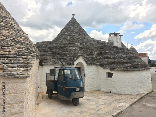 A vehicle in front of truli in Alberobello