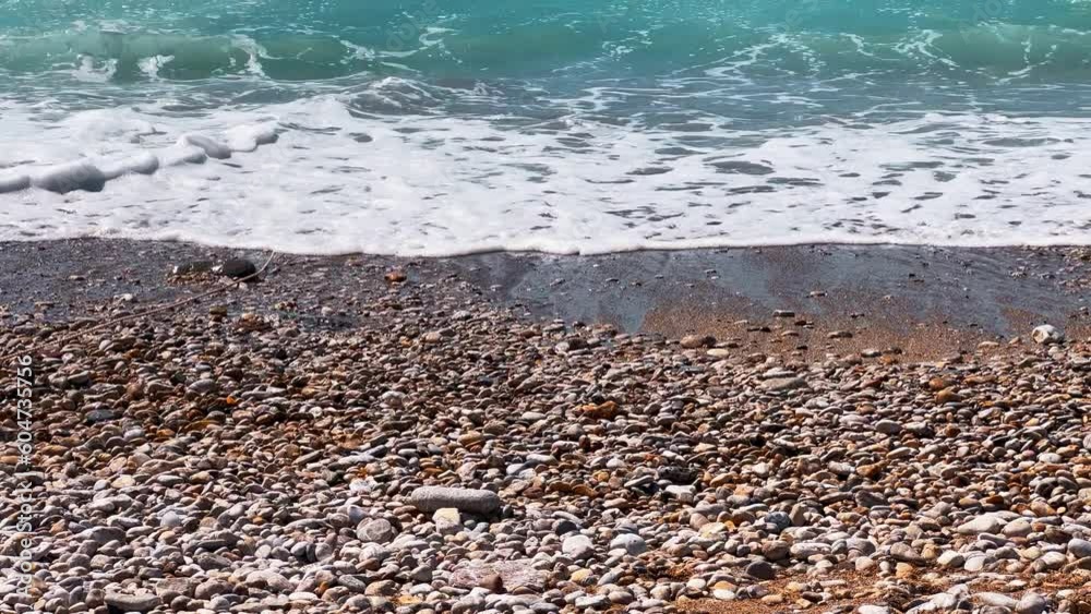 Waves breaking on pebbles. Close up. White foamy sea waves run over small pebbles on the shore. A calm summer day, sea, shingle beach, shoreline, coast and holiday travel concept
Waves breaking on pebbles. Close up. White foamy sea waves run over small pebbles on the shore. A calm summer day, sea, shingle beach, shoreline, coast and holiday travel concept