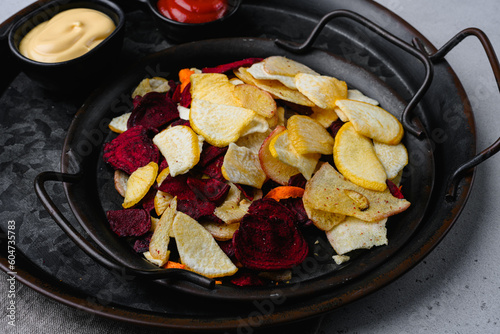 Root Vegetable Crisps, on gray stone table background