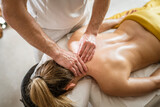 unknown woman enjoy neck massage at beauty spa male therapist
