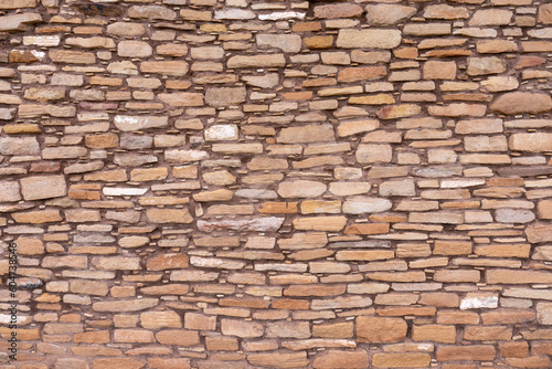 Stone pattern of a wall built by early Pueblos Indians with large cut stones set in mortar for the main structure and small ones to fill the gaps, Lowry Pueblo, Canyon of the Ancients NM, Colorado