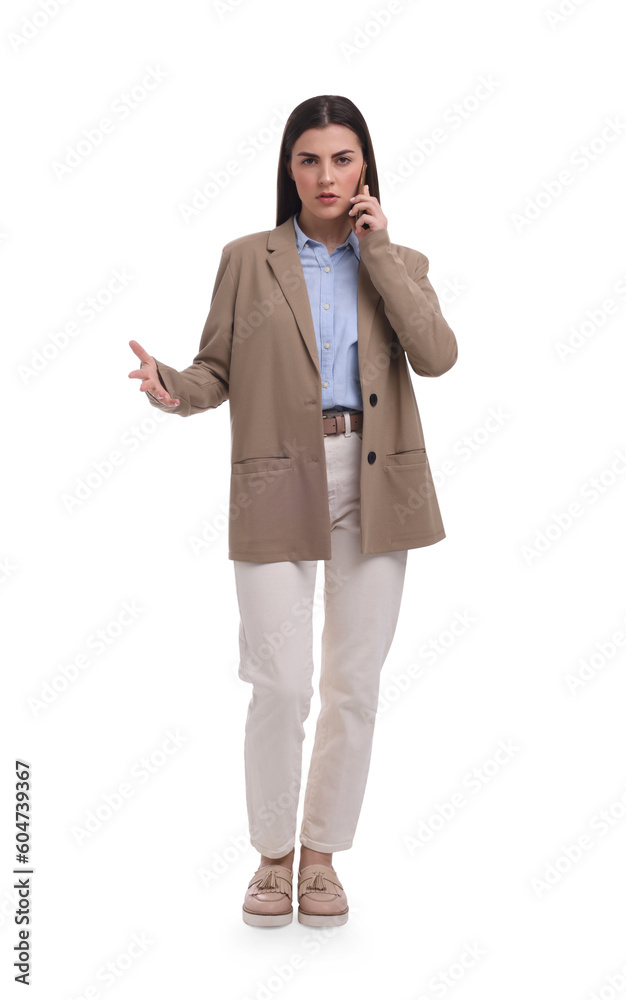 Beautiful businesswoman talking on smartphone against white background