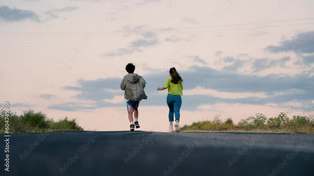 Slow motion two young people running with their friend at sunset Slow motion two young people running with their friend at sunset
