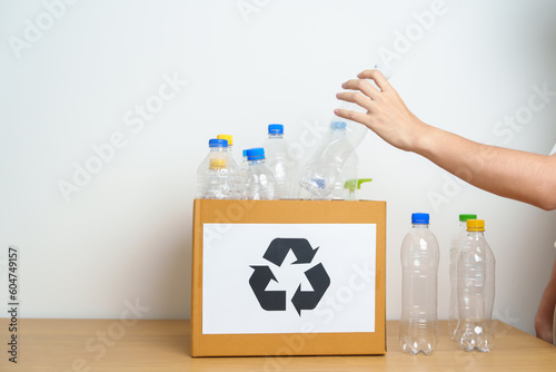 Volunteer keep plastic bottle into paper box at home or office. Hand Sorting Recycle garbage. Ecology, Environmental, pollution, Dispose recycling, waste management and trash Separation concept