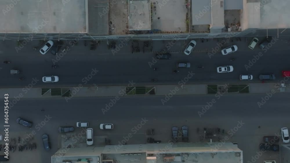 Karachi, Pakistan- Aerial drone top down shot over heavy traffic movement along a road crossing in karachi city, Pakistan during evening time.