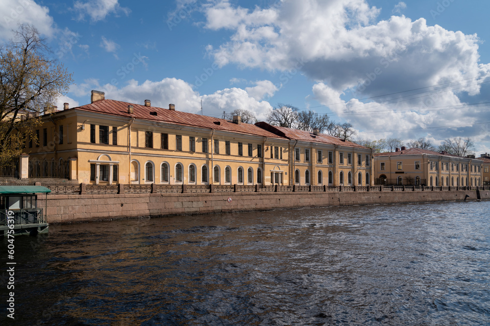 View of the academic buildings of the A.I. Herzen Russian State Pedagogical University on the Moika River embankment on a sunny day, Saint Petersburg, Russia