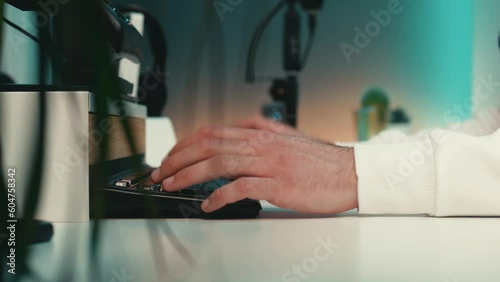 Wallpaper Mural Man’s hands type skillfully on a mechanical keyboard in a cozy home office. Teal and orange lights, black gadgets, and green plants create a funky and modern atmosphere. Close up. Torontodigital.ca