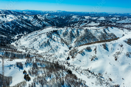 view from drone on car traveling along a winter mountain road serpentine, northern Kazakhstan, Asia.
