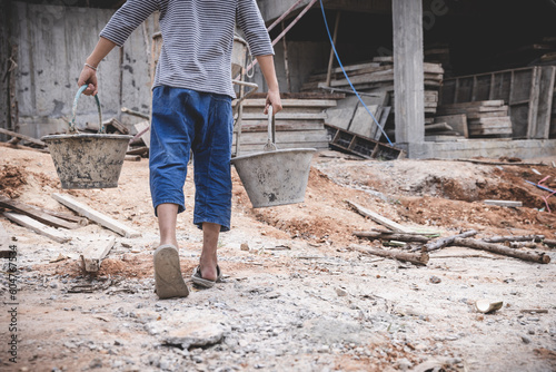 boys labor work in the construction site,  Against child labor, Poor children,  construction work, Violence children and trafficking concept