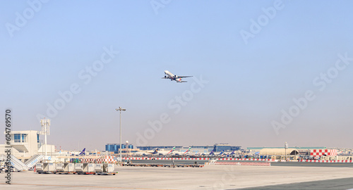 View from the window of a Flydubai aircraft moving along the runway to the standing planes of world airlines and the airport building at Dubai airport
