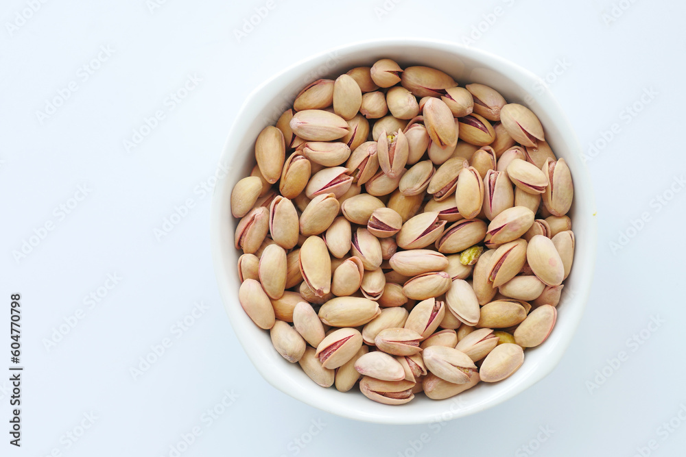 top view of pistachios nut on in bowl on white background top view of pistachios nut on in bowl on white background