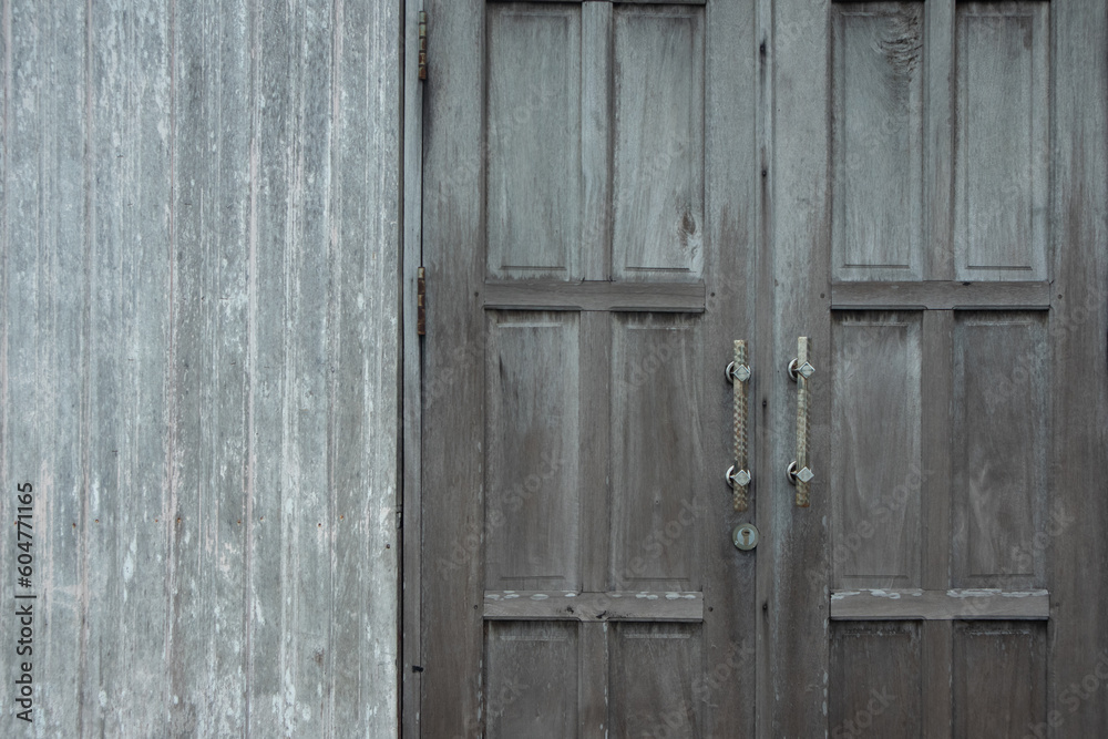 the backdrop doors and walls are old wood and the paint is chipped and damaged