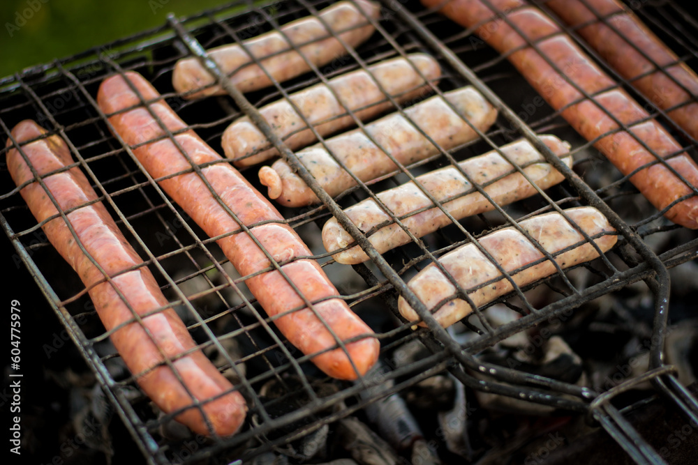 Sausage cooked on the grill outdoors. Grilled food, barbecue.
