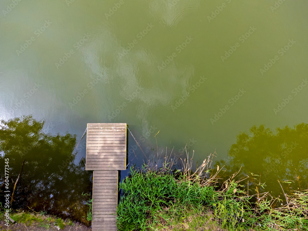 Aerial view landscape, drone view of lake and platform, footbridge for people, wooden path.