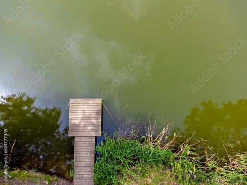 Obraz na płótnie Aerial view landscape, drone view of lake and platform, footbridge for people, wooden path. w salonie