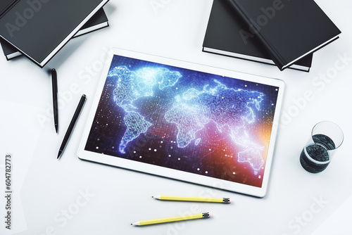 Modern digital tablet display with abstract creative world map, globalization concept. Top view. 3D Rendering