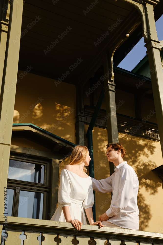 Young couple in love standing on balcony