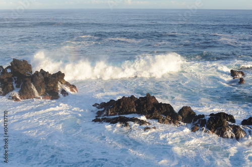Big waves crashing and breaking on the rocks on the coast of Atlantic Ocean in Madeira Island, Portugal