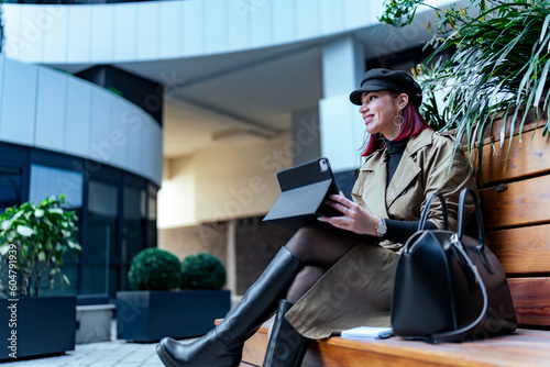 Fashion editor double-checking her pitch on a tablet before a business meeting, modern girl in a business world photo