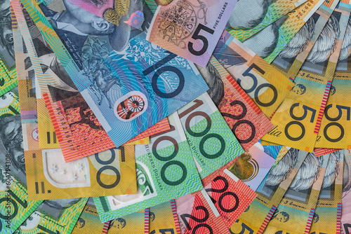 Colorful australian dollars laying on wooden table