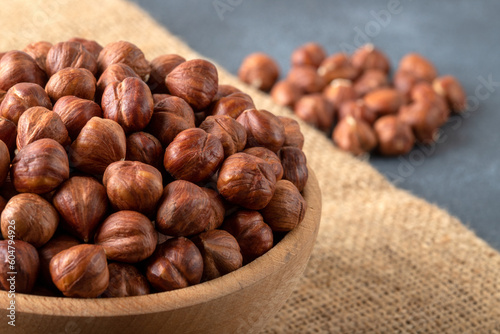 View of a bowl full of hazelnuts on a burlap sack,closeup 