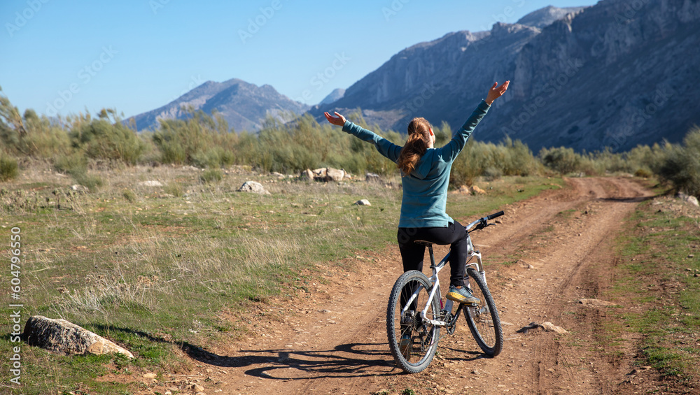 Woman in mountain bike in countryside