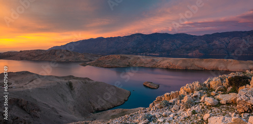 The rugged, rocky landscape of the island of Pag in Croatia shown during a beautiful sunset