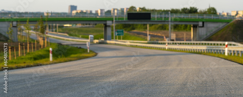 Newly constructed highway asphalt guardrails.In the background spring landscape