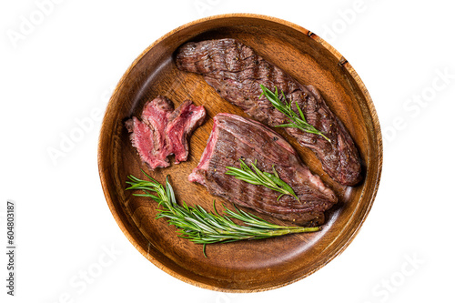 Fried sirloin flap or flank beef steak with herbs in a wooden plate.  Isolated, transparent background.