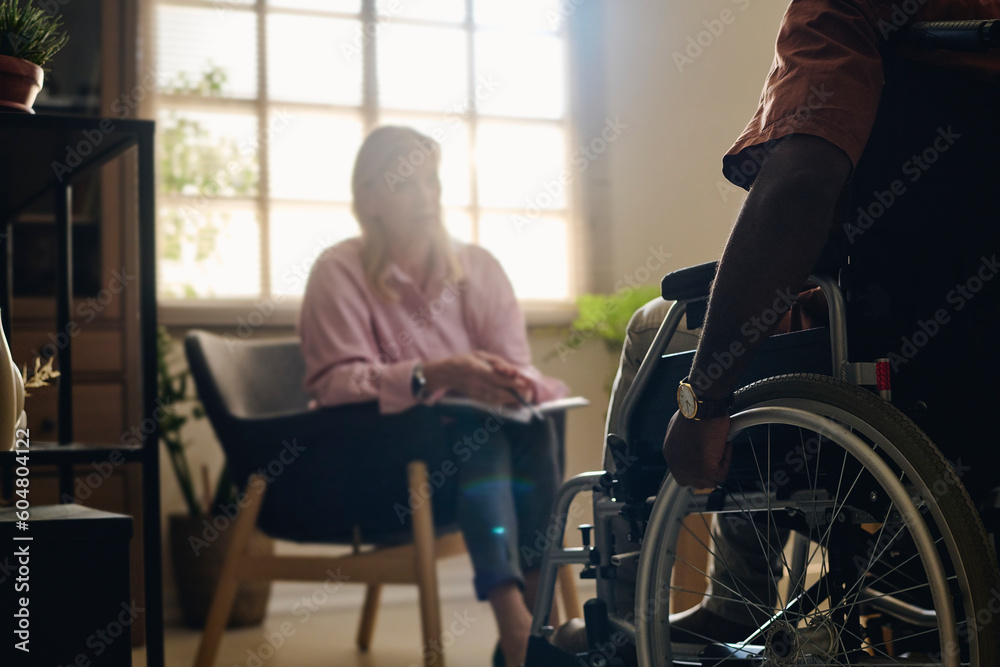 Patient with disability in therapy session with psychologist at office Patient with disability in therapy session with psychologist at office
