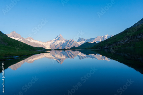 Fantastic evening panorama of Bachalp lake / Bachalpsee, Switzerland. Picturesque autumn sunset in Swiss alps, Grindelwald, Bernese Oberland, Europe. Beauty of nature concept background. © Martin