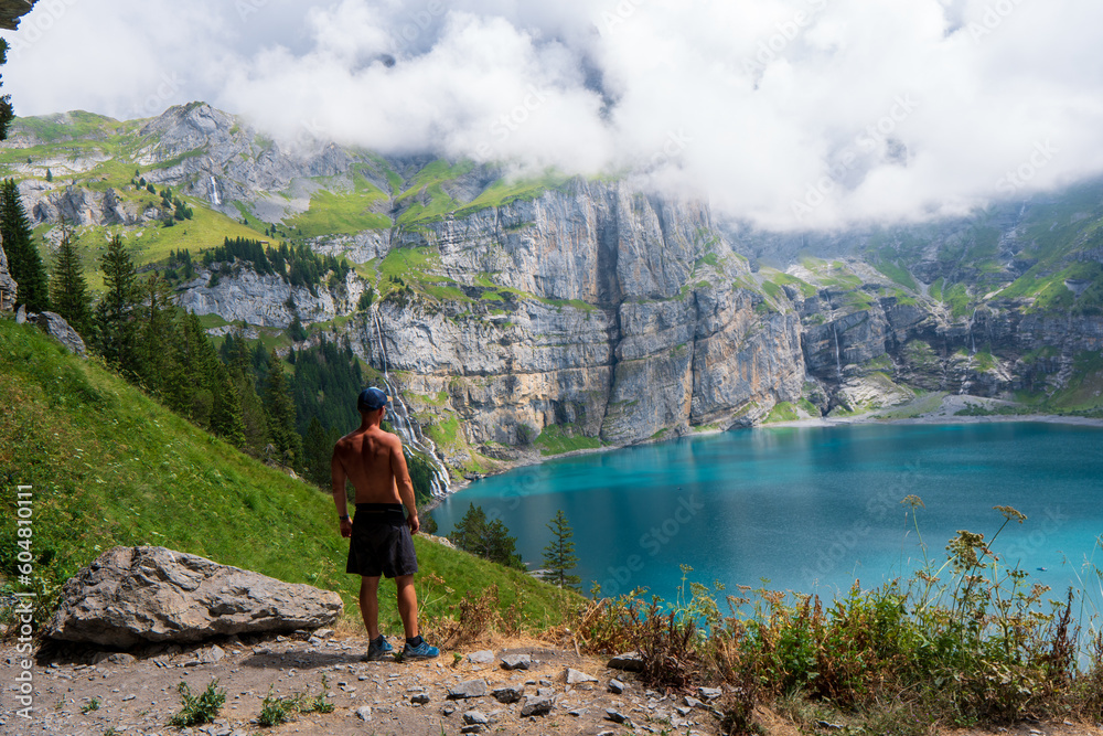 Tourist in the mountains in Switzerland on Lake Oeschinensee Tourist in the mountains in Switzerland on Lake Oeschinensee
