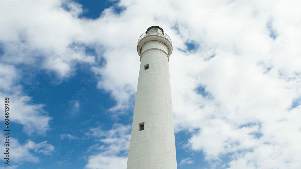 White tower lighthouse in daylight with clouds