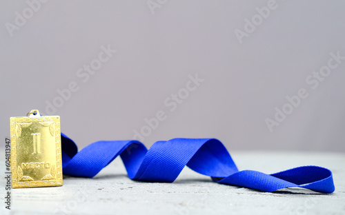 Square Gold medal for the first 1st place with a blue ribbon, the concept of leadership and leadership, victory