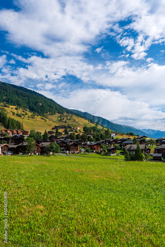 Ancient wooden traditional Swiss granaries and chalets on stone piles in an old abandoned village in Switzerland in mountains photo