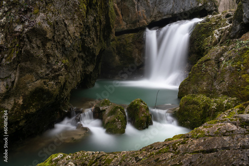 Waterfall with mossy rocks in mountain canyon in long exposure  Svrakava waterfall near Banja Luka