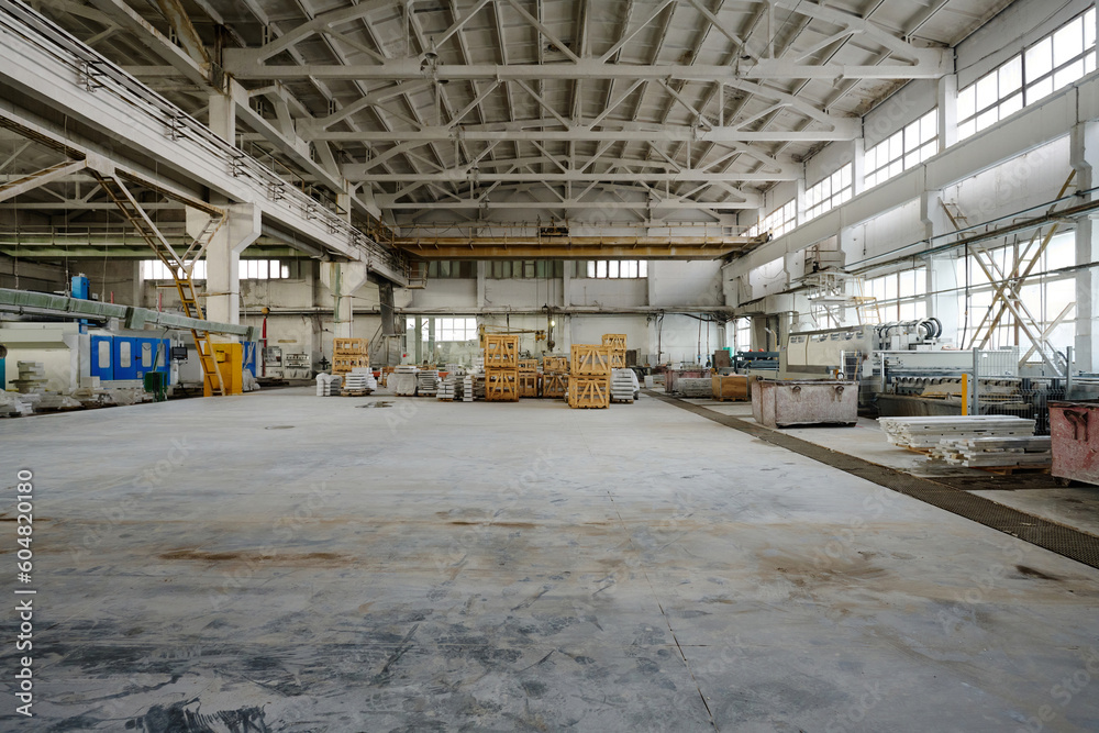 Horizontal image of big empty warehouse with equipment and materials Horizontal image of big empty warehouse with equipment and materials