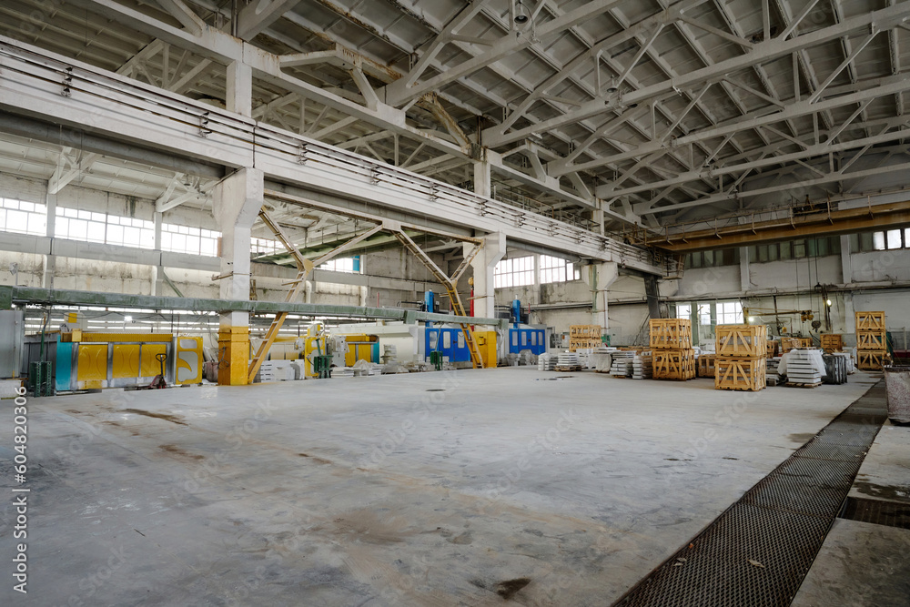 Horizontal image of big workshop with industrial machines and materials for production