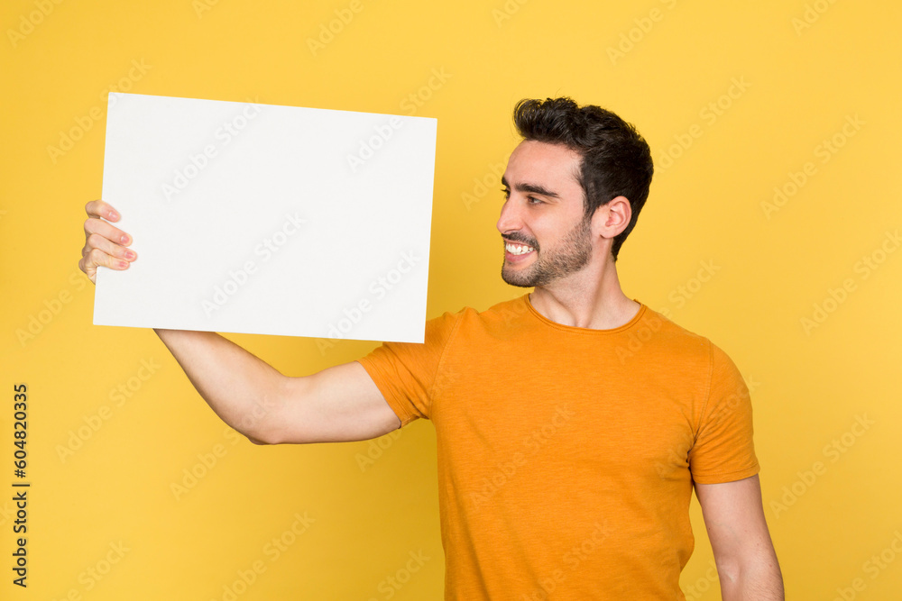 Smiling young man with blank advertising sign Smiling young man with blank advertising sign