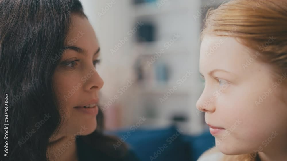 Closeup of adolescent daughter sharing a secret with her mother, trust and care Closeup of adolescent daughter sharing a secret with her mother, trust and care