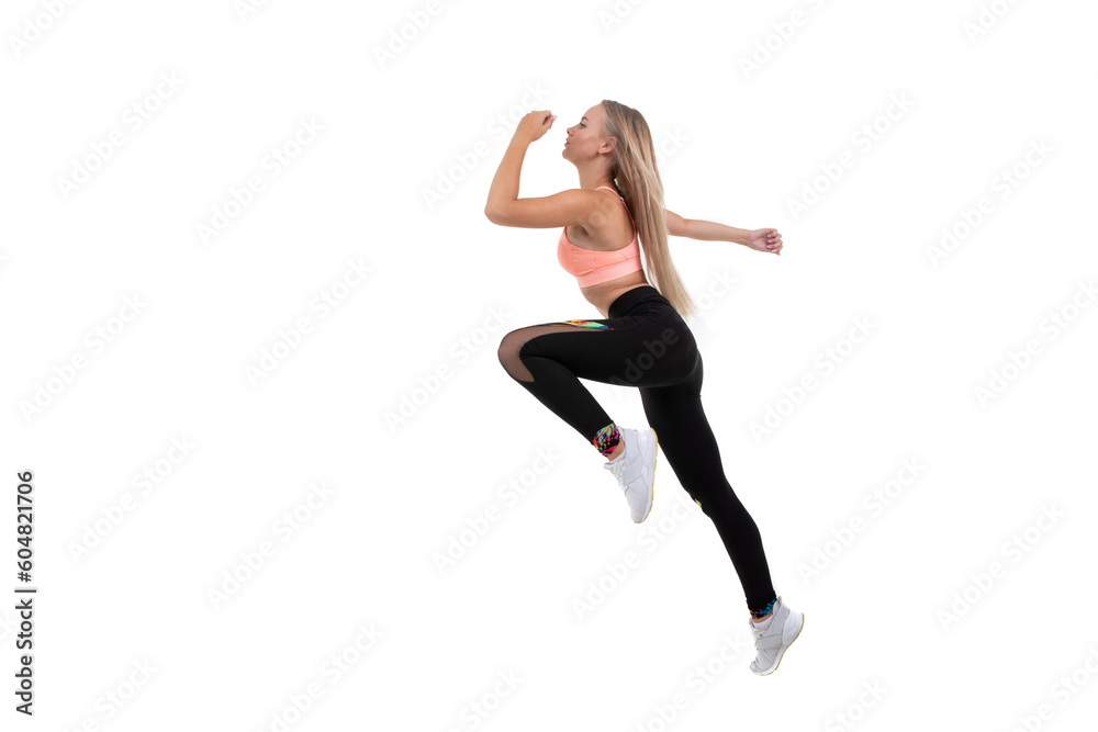 Sporty beautiful blonde in a pink top, leggings and sneakers runs forward on a white background