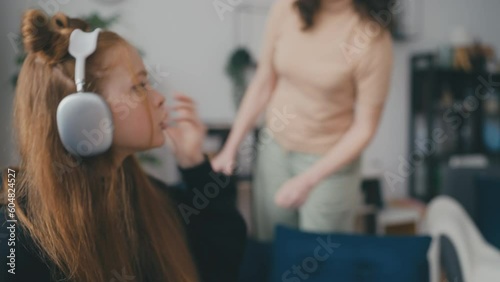 Teen girl talking rude to her mom at home, teenage rebellion, misunderstanding photo